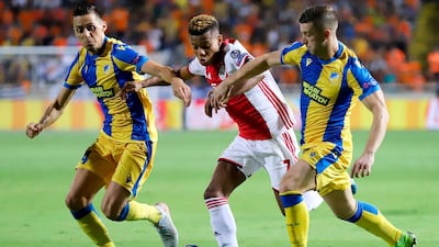 Ajax forward David Neres takes on the APOEL defence. AFP