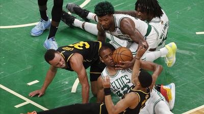 Boston Celtics' Al Horford, centre, lands on Golden State Warriors' Stephen Curry's leg, left, while going for a loose ball during a National Basketball Association (NBA) Finals playoff game. EPA