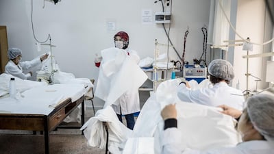 Teachers volunteer their time to help make bodysuits amid the Covid-19 outbreak at a Vocational and Technical Anatolian School in Istanbul, Turkey. Getty Images