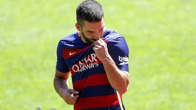 Arda Turan was presented as a Barcelona player on Friday and Atletico Madrid have moved quickly to replace the Turkey international. Alejandro Garcia / EPA