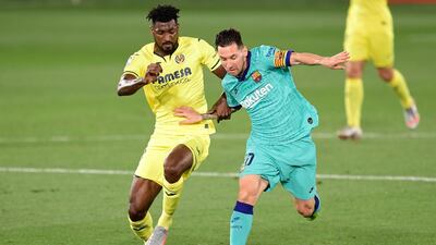 Lionel Messi keeps Villarreal's Cameroonian midfielder Andre-Frank Zambo Anguissa at arm's length. AFP