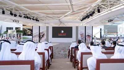 Dignitaries and guests look at Sandooq Al Watan presentation, during a Sea Palace barza. Ryan Carter for the Ministry of Presidential Affairs
