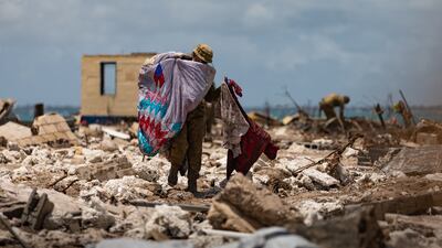 A handout photo made available by the Australian Government Department of Defence shows Australian Army soldiers 2nd Combat Engineer Regiment clearing debris on Atata Island, Tonga.