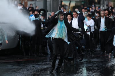 Police use water cannon on ultra-Orthodox protesters, demonstrating against army recruitment, in Jerusalem. EPA