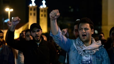 Protesters shout slogans as they block the main highway during ongoing anti-government protests near downtown in Beirut, Lebanon. EPA