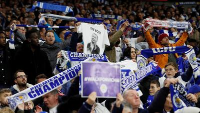 Cardiff City v Leicester City - Cardiff City Stadium, Cardiff, Britain - Leicester City fans celebrate after Demarai Gray scores their first goal and hold signs in remembrance of Vichai Srivaddhanaprabha, late chairman of Leicester City Football Club. Reuters