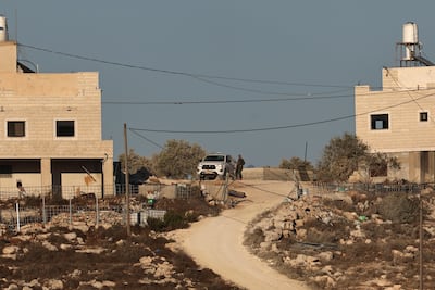 Israeli soldiers stand guard near residential properties belonging to the Palestinian Tobasi family following their takeover by Israeli settlers in Jalud. EPA