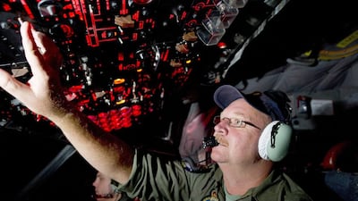 Australia’s Department of Defence shows Royal Australian Air Force (RAAF) flight engineer Warrant Officer Neil Scott-Jackson on-board an AP-3C Orion on route to RAAF Base Pearce in Western Australia after searching the southern Indian Ocean. Leading Seaman Justin Brown / Australian Defence / AFP