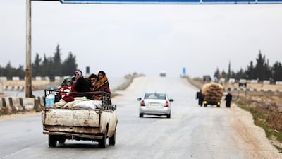 Displaced people from a village in southern Idlib head towards the northern part of the rebel-held province on January 5, 2018 as they flee a government military offensive. Omar Haj Kadour / AFP
