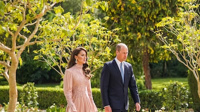 The Princess of Wales chose a blush pink long-sleeved dress and kept her hair down in loose curls. PA
