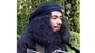 This undated photo provided by Joint Task Force Sulu, Filipino militant Talha Jumsah, who used the nom de guerre Abu Talha, walks in the jungles of Patikul, Sulu province, southern Philippines. Philippine military officials say troops have killed Jumsah, a "high-value" Filipino militant, who acted as a key link of the Islamic State group to local jihadists and helped set up a series of deadly suicide attacks in the south that have alarmed the region. (Joint Task Force Sulu via AP)