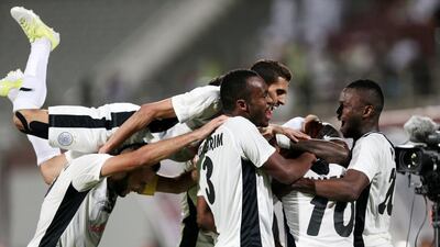 Al Sadd players celebrate scoring against Al Wahda during their AFC Champions League play-off match at Al Nahyan Stadium in Abu Dhabi on February 17. Christopher Pike / The National