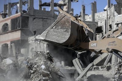 A bulldozer clears debris from a street in Gaza city. Bloomberg