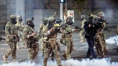 Federal officers use chemical irritants and crowd control munitions to disperse Black Lives Matter protesters in Portland. AP