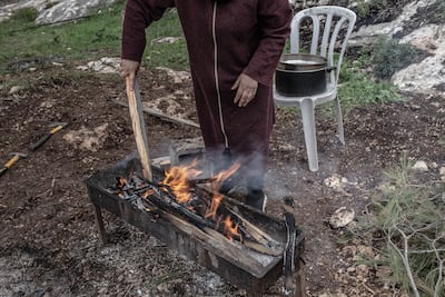Many of Jenin's displaced who took to the hills live in cargo containers, heating food on fires or portable cookers. Patricia Martinez / The National