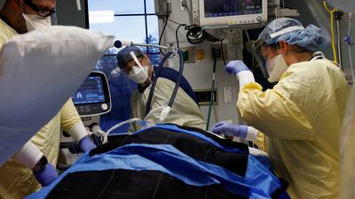 Medical staff treat a Covid-19 patient in their isolation room in the ICU unit at Western Reserve Hospital in Cuyahoga Falls, Ohio, on January 4. Reuters