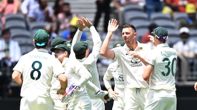 Josh Hazlewood celebrates with teammates taking the wicket of Devdutt Padikkal. The Australian bowler finished with figures of 4-29. EPA