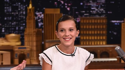 Millie Bobby Brown, wearing a white dress with black detail, appears on the 'Tonight Show Starring Jimmy Fallon' in New York City on August 31, 2016. Getty Images