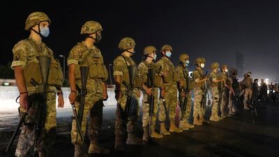 Lebanese army soldiers stand guard as anti-government protesters block a main highway during a demonstration against deteriorating economic conditions as politicians are deadlocked over forming a new government, in the town of Jal el-Dib, north of Beirut. AP Photo