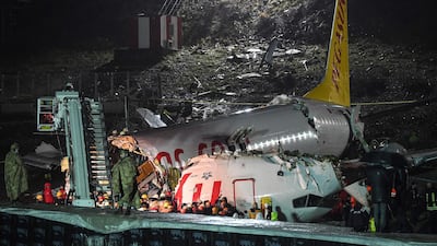 Turkish soldiers stand guard as rescuers work to extract passengers from the crash of a Pegasus Airlines Boeing 737 airplane, after it skidded off the runway upon landing at Sabiha Gokcen airport in Istanbul on February 5, 2020. The plane carrying 171 passengers from the Aegean port city of Izmir split into three after landing in rough weather. Officials said no-one had lost their lives in the accident, but dozens of people were injured. / AFP / Ozan KOSE
