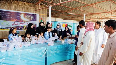 Ras Al Khaimah's girl guides implement their iftar project whereby they distribute iftar meals to labourers.