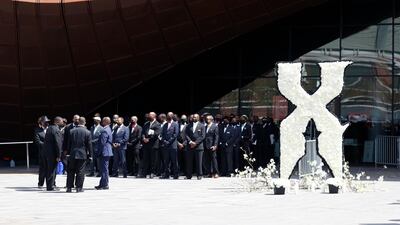 Members of the Nation of Islam are seen next to an X floral arrangement outside the Barclays Centre where a private memorial for US rapper DMX is being held in Brooklyn, New York. EPA