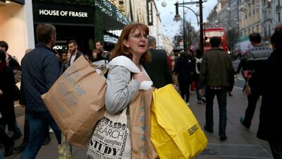 A woman carries several shopping bags as she shops on Oxford Street in London, England. Why are women being charged more for the same product? (Photo by Carl Court/Getty Images)