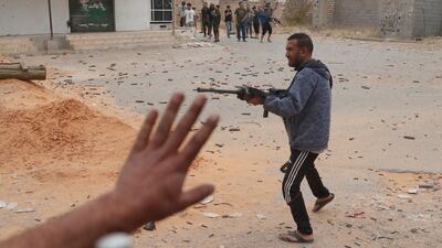 A GNA fighter pulls the trigger on his rifle. Reuters