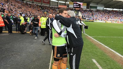 Hull City manager Steve Bruce embraces his son, Alex, before a last-minute penalty kick. Mike Egerton / PA Sport