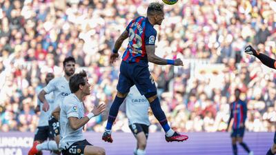 Barcelona's Raphinha scores his side's opening goal during Spanish La Liga soccer match between Barcelona and Valencia at the Camp Nou stadium in Barcelona, Spain, Sunday, March 5, 2023. (AP Photo / Joan Monfort)