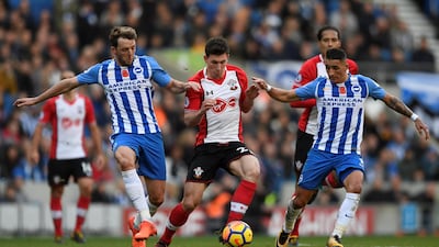 Southampton's Pierre-Emile Hojbjerg, centre, in action with Brighton's Dale Stephens and Anthony Knockaert. Tony O'Brien / Reuters