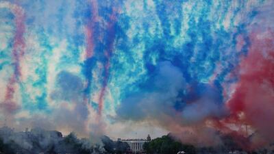 Red and blue smoke is fired at the Ellipse of the White House during the "Salute to America" event held to celebrate Independence Day in Washington in 2020. Reuters