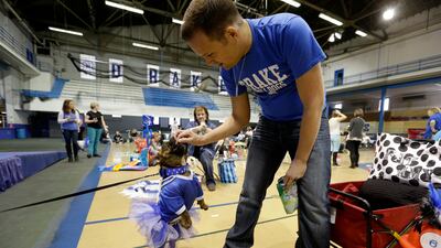 Dustin Reese, of Des Moines, Iowa, gives a treat to Fat Amy for her efforts in the pageant.