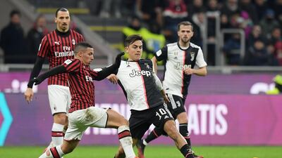 Juventus attacker Paulo Dybala battles for possession with Milan's Ismael Bennacer. Reuters