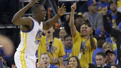 Golden State Warriors forward Draymond Green reacts in front of fans during the first half of an NBA basketball game against the Memphis Grizzlies in Oakland, California, Wednesday, April 13, 2016. (AP Photo/Marcio Jose Sanchez)