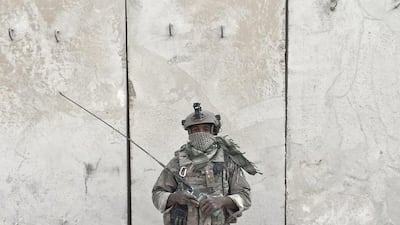 S Air Force Senior Airman Dennis Marshall, 26, from Memphis, Tennessee, poses for a portrait while holding his radio at the Qayara West Coalition base in Qayara.