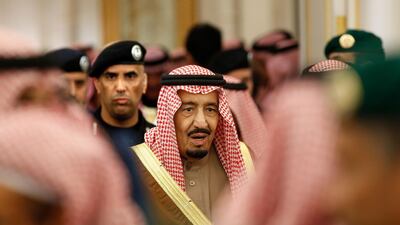 King Salman is guarded by his bodyguard Maj Gen Abdulaziz Al Fagham, back ground, as he attends a ceremony at the Diwan royal palace in Riyadh. AP Photo