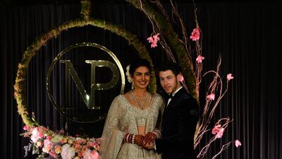 Newlyweds Priyanka Chopra, 36, and Nick Jonas, 26, pose for a photograph during a reception at a hotel in New Delhi on December 4, 2018. Photo: AFP