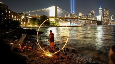A man creates his own light show as the Tribute in Light installation marks the 24th anniversary of the September 11 attacks on the World Trade Centre, in New York. Reuters