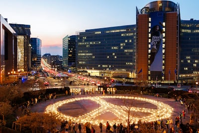 Candles and lights are laid out at a peace vigil in front of the European Council and Commission buildings in Brussels. AP