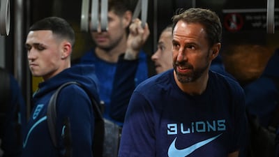 England's manager Gareth Southgate with his team at the Hamad International Airport in Doha. AFP