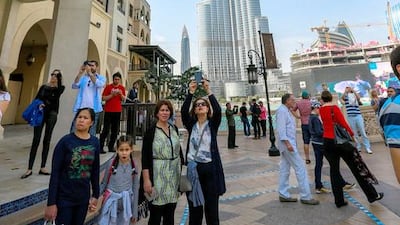Visitors take pictures of the fire damage sustained to The Address Hotel in Dubai.