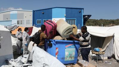 Refugees and migrants who were sheltered near the destroyed Moria camp, carry their belongings as they prepare to move to a new temporary camp, on the island of Lesbos, Greece. Reuters