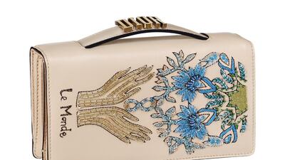 Dior decorates a simple clutch with naive hand beading and embroidery, which, against the metal hardware on the handle, looks all the more dainty. Courtesy Christian Dior.