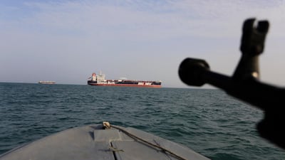 A speedboat of Iran's Revolutionary Guard trains a weapon toward the British-flagged oil tanker Stena Impero, which was seized in the Strait of Hormuz on July 19 by the Guards. Tasnim News Agency via AP, file