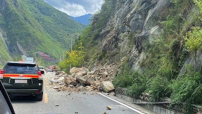The quake triggered landslides on the road heading into Luding county. AP