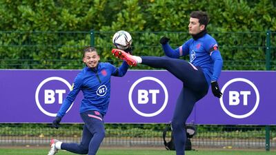 Kalvin Phillips, left, and Harry Maguire battle for the ball during training. PA