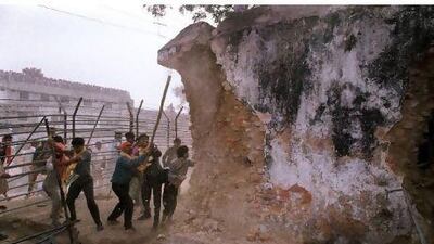 Hindu fundamentalists seen attacking the wall of the 16th century Babri Masjid Mosque with iron rods at the disputed holy site in the city of Ayodhya in December 1992. India's Supreme Court has suspended a ruling that partitioned the site into three, one for Hindus, one for Muslims and one for a local Hindu trust.