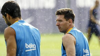 Barcelona’s Lionel Messi, with Luis Suarez to his left, shown on Thursday at the Barca club training session. Quique Garcia / AFP