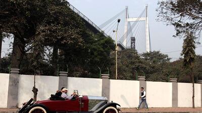 A 1923 Rolls Royce passes the second Hooghly Bridge across the Ganges River during the Statesman vintage and classic car rally in Kolkata. Bikas Das / AP Photo